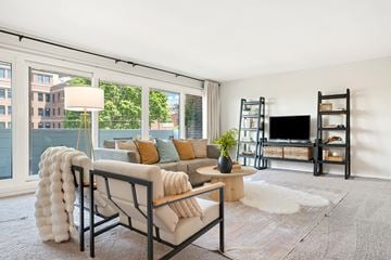 Easton apartment for rent - A living room with a white couch and a black chair.