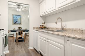 Easton apartment for rent - A kitchen with white cabinets and a marble countertop.
