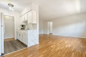 Allentown apartment for rent - A kitchen with white cabinets and a marble island.