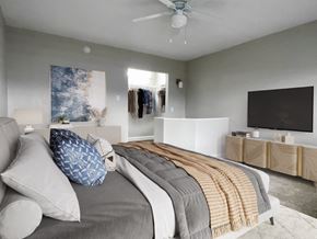St. Peterburg apartment for rent - a bedroom with a bed and a ceiling fan