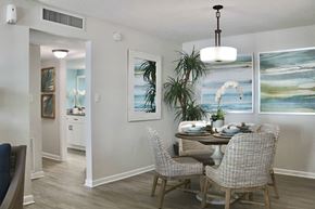 Clearwater apartment for rent - A dining room with a table set for two and a painting on the wall.