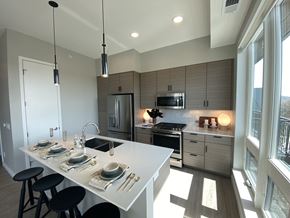 Minneapolis apartment for rent - a kitchen with gray cabinets and a white island