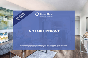 Toronto apartment for rent - A room with a couch and a coffee table with a QuadReal advertisement on the wall.
