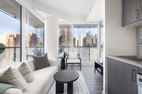 Toronto apartment for rent - A modern living room with a view of the city skyline.