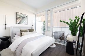 Toronto apartment for rent - A bedroom with a large bed and a painting on the wall.