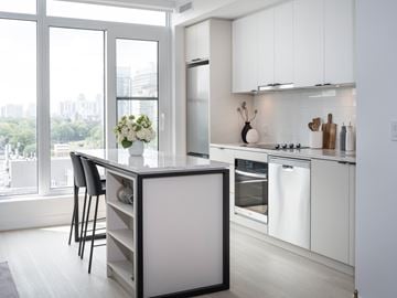 Toronto apartment for rent - A modern kitchen with white cabinets and a large island.