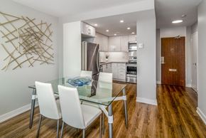 Mississauga apartment for rent - Open concept kitchen and dining room staged with furniture. The kitchen is open from the dining room.