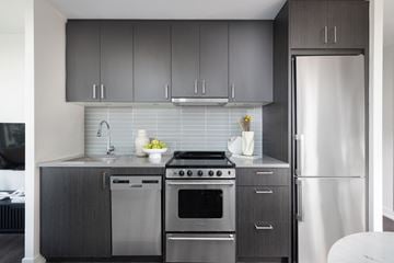 Toronto apartment for rent - A modern kitchen with a stainless steel refrigerator and oven.