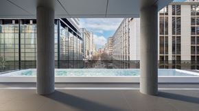Toronto apartment for rent - a pool in the middle of a building with buildings in the background