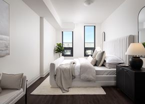 Mississauga apartment for rent - a bedroom with white walls and a bed with pillows and blankets