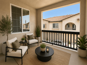 Moreno Valley apartment for rent - A balcony with a table and chairs overlooking a building.