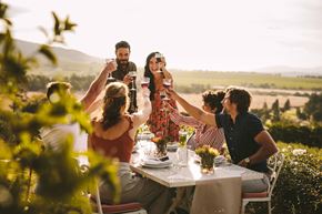 Johnson City apartment for rent - A group of people are gathered around a table in a garden.