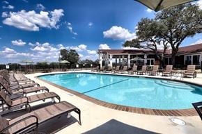 Johnson City apartment for rent - A large outdoor swimming pool surrounded by sun loungers.
