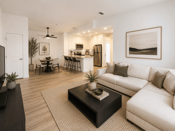 Moreno Valley apartment for rent - A modern living room with a white couch, a black coffee table, and a dining table with chairs.