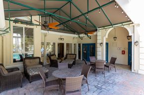 Kissimmee apartment for rent - a patio area with tables and chairs at Saratoga Resort Villa Apartments, Kissimmee, FL,  34746