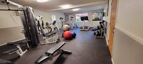 Bellflower apartment for rent - a gym with cardio equipment and exercise balls on the floor at Villa La Paz Apartments, California, 90706