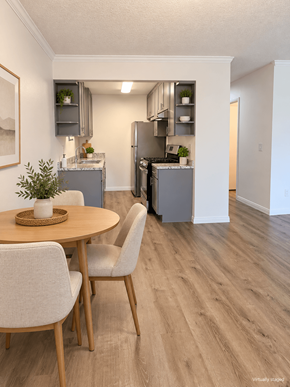 Bellflower apartment for rent - A kitchen with a table and chairs in the foreground and a refrigerator in the background.
