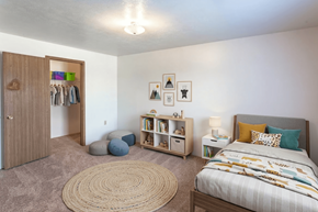 Cullman apartment for rent - A bedroom with a bed, a wardrobe, and a rug.