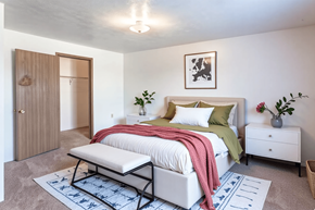 Manchester apartment for rent - A bedroom with a bed, nightstand, and a rug.