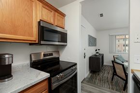 Clio apartment for rent - A kitchen with a stove top oven and microwave above it.