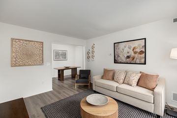 Clio apartment for rent - A living room with a white couch and a coffee table.