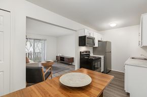 Clio apartment for rent - A kitchen with a table and chairs in the foreground.