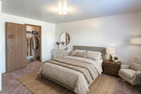 Manchester apartment for rent - A bedroom with a large bed, a chair, and a wardrobe.