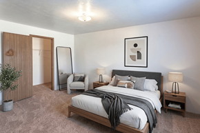 Cullman apartment for rent - A bedroom with a large bed and a chair.