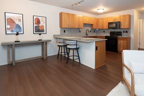 Grayling apartment for rent - A kitchen with wooden cabinets and a white countertop.