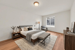 Manchester apartment for rent - A bedroom with a large bed and a window.