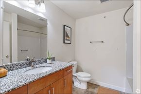 Toledo apartment for rent - A bathroom with a toilet, sink, and mirror.