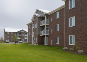 St. Clair apartment for rent - A large apartment complex with a grassy area in front.