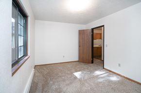 Harbor Beach apartment for rent - an empty living room with a window and a door to a bathroom