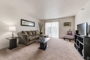 Fenton apartment for rent - the living room of our apartments with a couch and a tv