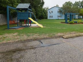 Gladwin apartment for rent - a playground with a yellow slide in a park