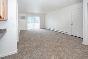 Dewitt apartment for rent - an empty living room with a door to a balcony