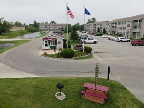 Cicero apartment for rent - a red picnic bench sitting in front of a parking lot with an flag