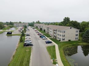 Cicero apartment for rent - an aerial view of a street with cars parked next to a river