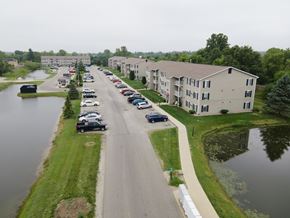 Cicero apartment for rent - an aerial view of an apartment complex with a river and cars parked on the street
