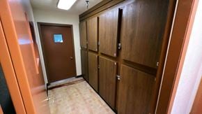 Sebewaing apartment for rent - a row of lockers in a hallway of a building