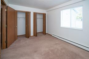Caledonia apartment for rent - a bedroom with two closets and a window and a carpet