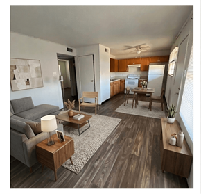 Linden apartment for rent - A living room with a grey couch, a wooden coffee table, and a kitchen area in the background.