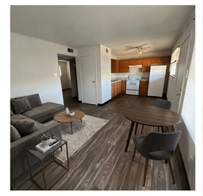 Linden apartment for rent - A living room with a grey couch, a coffee table, and a dining table.