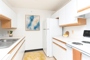 Evansville apartment for rent - A kitchen with white cabinets and a white fridge.