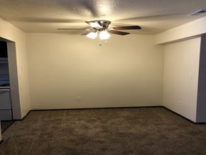 Ionia apartment for rent - a room with a ceiling fan and a carpet