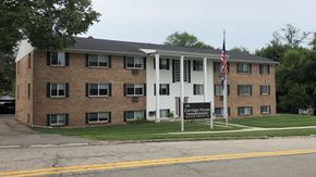 Portland apartment for rent - a large brick apartment building with a sign in front of it