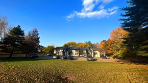Coopersville apartment for rent - a house with a carport and a lawn in front of it