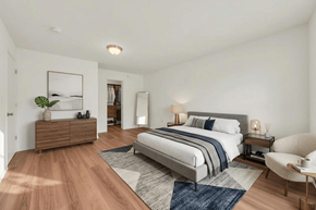 Manchester apartment for rent - A bedroom with a large bed and a chair.