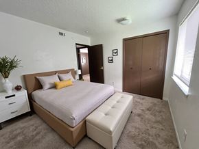 Baytown apartment for rent - A bedroom with a large bed and a white dresser.