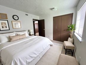 Mt. Vernon apartment for rent - A bedroom with a large bed and a brown wardrobe.